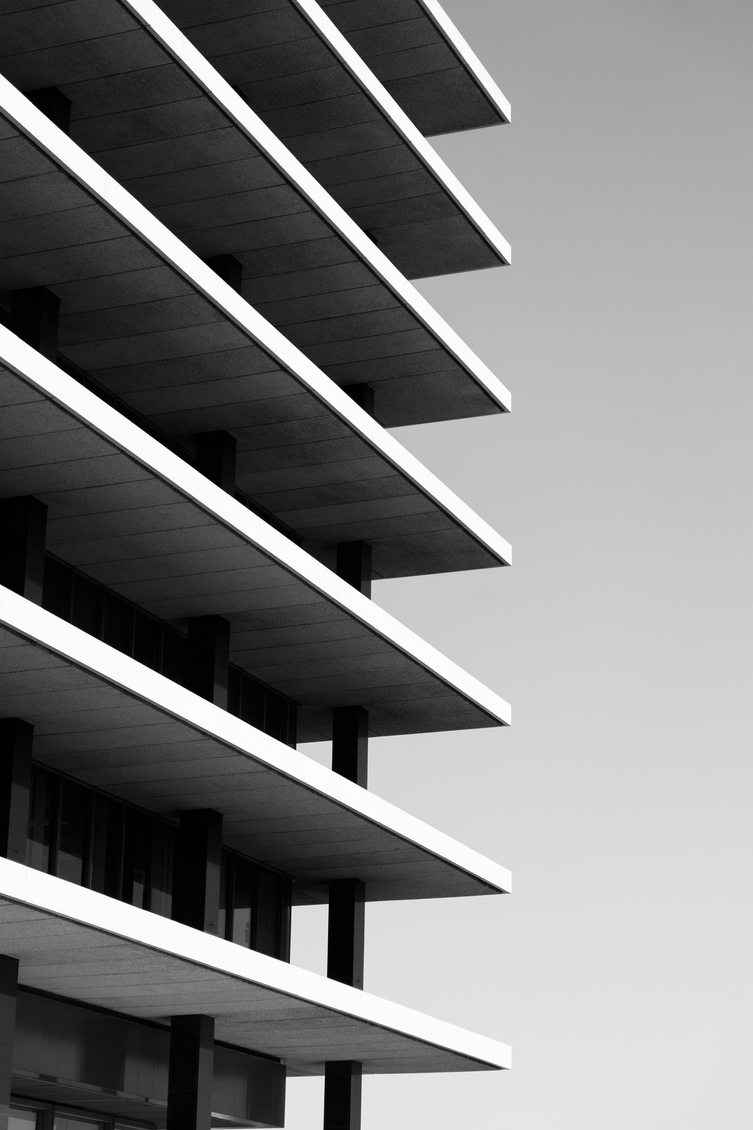 Stacked white balcony fins receding along a facade